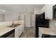 Functional kitchen with white cabinets, stainless steel sink, and wood-look flooring at 9810 Campus Walk Ln # G, Charlotte, NC 28262