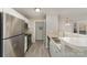 Modern kitchen with stainless steel fridge, bar seating, and open layout at 9810 Campus Walk Ln # G, Charlotte, NC 28262