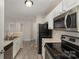 Clean kitchen design, featuring updated appliances and fixtures, ample cabinet space at 9810 Campus Walk Ln # G, Charlotte, NC 28262