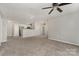 Spacious living room featuring neutral walls and plush carpet flooring with views into the kitchen at 9810 Campus Walk Ln # G, Charlotte, NC 28262