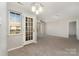 Inviting living room showcasing neutral walls, plush carpet flooring, and abundant natural light at 9810 Campus Walk Ln # G, Charlotte, NC 28262