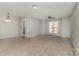 Cozy living room featuring neutral walls, plush carpet flooring, and ample natural light at 9810 Campus Walk Ln # G, Charlotte, NC 28262