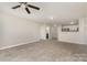 Comfortable living room with plush carpet flooring, neutral walls, and natural light at 9810 Campus Walk Ln # G, Charlotte, NC 28262