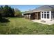 Large backyard with lush green lawn, a screened-in porch, and a fire pit, perfect for outdoor entertainment at 1021 Glen Laurel Dr, Fort Mill, SC 29707