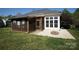Spacious backyard with green lawn, screened-in porch, and a cozy fire pit, ideal for outdoor gatherings at 1021 Glen Laurel Dr, Fort Mill, SC 29707