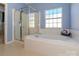 Bathroom featuring a separate shower and a soaking tub, offering a luxurious experience at 1021 Glen Laurel Dr, Fort Mill, SC 29707