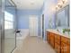 Bright bathroom with a tub, enclosed glass shower, and wood cabinets; a serene space at 1021 Glen Laurel Dr, Fort Mill, SC 29707