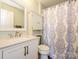 Bright bathroom featuring a patterned shower curtain, white vanity with gold pulls, and a modern faucet at 1021 Glen Laurel Dr, Fort Mill, SC 29707
