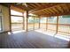 Inviting sunroom with wood floors, screened windows, and a ceiling fan, perfect for relaxing outdoors at 1021 Glen Laurel Dr, Fort Mill, SC 29707
