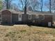 Brick home's backyard features a spacious layout with patio, perfect for outdoor activities at 10607 Wood Meadow Dr, Charlotte, NC 28227