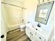 Bathroom featuring modern vanity with solid surface top, updated fixtures, and tub and shower combination at 10607 Wood Meadow Dr, Charlotte, NC 28227
