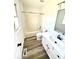 Bright bathroom with a white vanity, new floor, and shower-tub combo at 10607 Wood Meadow Dr, Charlotte, NC 28227