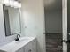 Well-lit bathroom featuring vanity with a solid surface top, modern fixture, and mirror at 10607 Wood Meadow Dr, Charlotte, NC 28227