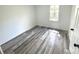 Bright bedroom featuring sleek, grey wood-look flooring and fresh, neutral paint at 10607 Wood Meadow Dr, Charlotte, NC 28227