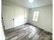 Bedroom featuring neutral walls, flooring, and trim with double closet and window at 10607 Wood Meadow Dr, Charlotte, NC 28227