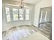 Bright dining area with a bay window and modern light fixture at 10607 Wood Meadow Dr, Charlotte, NC 28227