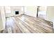 Bright living room featuring a fireplace and neutral walls complemented by stylish, light-colored flooring at 10607 Wood Meadow Dr, Charlotte, NC 28227