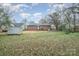 This home features a generously-sized backyard with mature trees and a storage shed at 108 White Oak St, Chester, SC 29706