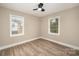 Bright bedroom featuring wood-look vinyl flooring and natural lighting from two windows at 108 White Oak St, Chester, SC 29706