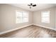 Bedroom featuring wood-look vinyl floors, natural lighting, and a ceiling fan at 108 White Oak St, Chester, SC 29706