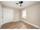 This cozy bedroom features wood-look floors, a ceiling fan, and a convenient closet at 108 White Oak St, Chester, SC 29706