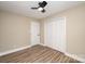 This simple bedroom features wood-look floors, a ceiling fan, and a convenient closet at 108 White Oak St, Chester, SC 29706