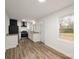 Kitchen with white cabinets, granite counters, stainless steel appliances, and wood-look vinyl flooring at 108 White Oak St, Chester, SC 29706