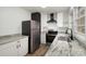 Updated kitchen features granite countertops, stainless steel appliances, and black and white cabinetry at 108 White Oak St, Chester, SC 29706