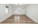 A bright and airy living room featuring newly installed floors, fresh paint, and modern lighting at 108 White Oak St, Chester, SC 29706