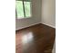 Bedroom with wood-look floors and a window with a view of the outdoors at 11022 Harrowfield Rd, Charlotte, NC 28226