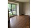 Bedroom with wood-look floors and a large window overlooking the front yard at 11022 Harrowfield Rd, Charlotte, NC 28226