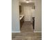 Functional kitchen layout with wood-look tile floor, closet, and white appliances and trim at 11022 Harrowfield Rd, Charlotte, NC 28226