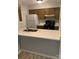 Bright kitchen featuring a breakfast bar, black appliances, and ample countertop space at 11022 Harrowfield Rd, Charlotte, NC 28226