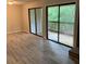 Bright living room with sliding glass doors leading to a deck, and brick fireplace at 11022 Harrowfield Rd, Charlotte, NC 28226
