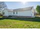 Backyard with siding, brick foundation, grassy yard, and blue sky at 121 Wichita Dr, Shelby, NC 28152