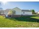 View of backyard features siding, brick foundation, and green grass at 121 Wichita Dr, Shelby, NC 28152