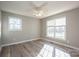 Bright bedroom featuring hard wood floors, a ceiling fan, and a view through several windows at 121 Wichita Dr, Shelby, NC 28152