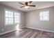 A well-lit bedroom with ample windows, hardwood flooring, and a modern ceiling fan at 121 Wichita Dr, Shelby, NC 28152