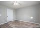A bedroom featuring modern ceiling fan, neutral walls, and wood-look flooring at 121 Wichita Dr, Shelby, NC 28152