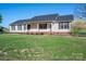 Classic single-story home featuring a covered porch and neat front yard landscaping at 121 Wichita Dr, Shelby, NC 28152