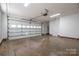 Garage with door to outside, large garage door, white walls, and concrete floor at 121 Wichita Dr, Shelby, NC 28152