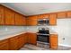Well-lit kitchen with stainless appliances, abundant wood cabinets, and neutral walls offers a great space at 121 Wichita Dr, Shelby, NC 28152