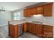Kitchen features wood cabinets, a stainless dishwasher, and a bar overlooking the sink area at 121 Wichita Dr, Shelby, NC 28152