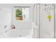 Bright bathroom featuring a soaking tub, shower, and large window for natural light at 13521 Michael Lynn Rd, Charlotte, NC 28278