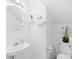 Bathroom features a pedestal sink, modern fixtures, and white walls at 13521 Michael Lynn Rd, Charlotte, NC 28278