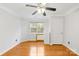 Bedroom features hardwood floors, a window, closet, and ceiling fan at 13521 Michael Lynn Rd, Charlotte, NC 28278