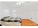 Upstairs bedroom featuring a window, wood floors, and sloped ceilings at 13521 Michael Lynn Rd, Charlotte, NC 28278