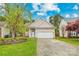 Charming home featuring neutral siding, a two-car garage, and a well-manicured front lawn at 13521 Michael Lynn Rd, Charlotte, NC 28278