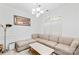 Cozy living room featuring a large sectional sofa, chandelier, and serene ambiance for relaxation at 13521 Michael Lynn Rd, Charlotte, NC 28278