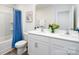Elegant bathroom with double vanity, modern fixtures, and bathtub with blue shower curtain at 140 Falling Up Ln, Salisbury, NC 28147